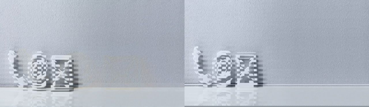 Phone and email icons against a wall