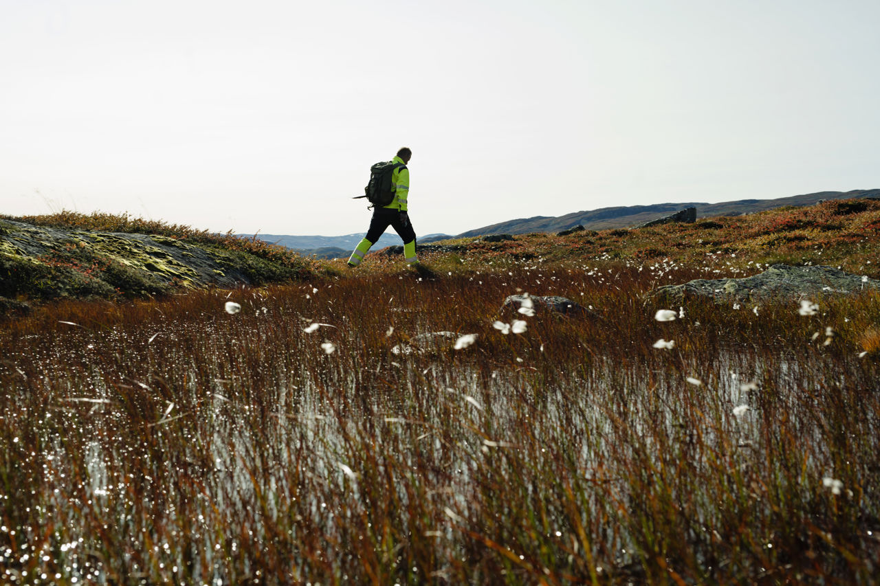 Man in distance walking across hills