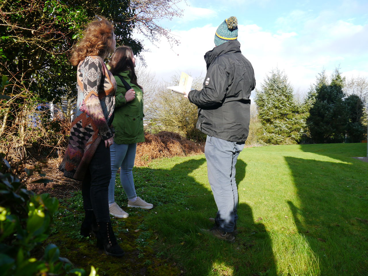3 people speaking outside a building