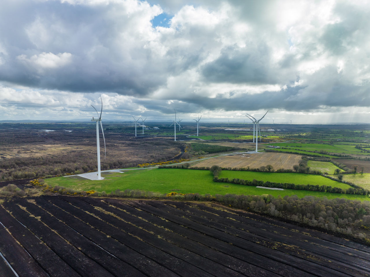Landscape shot of 9 turbines on a wind farm