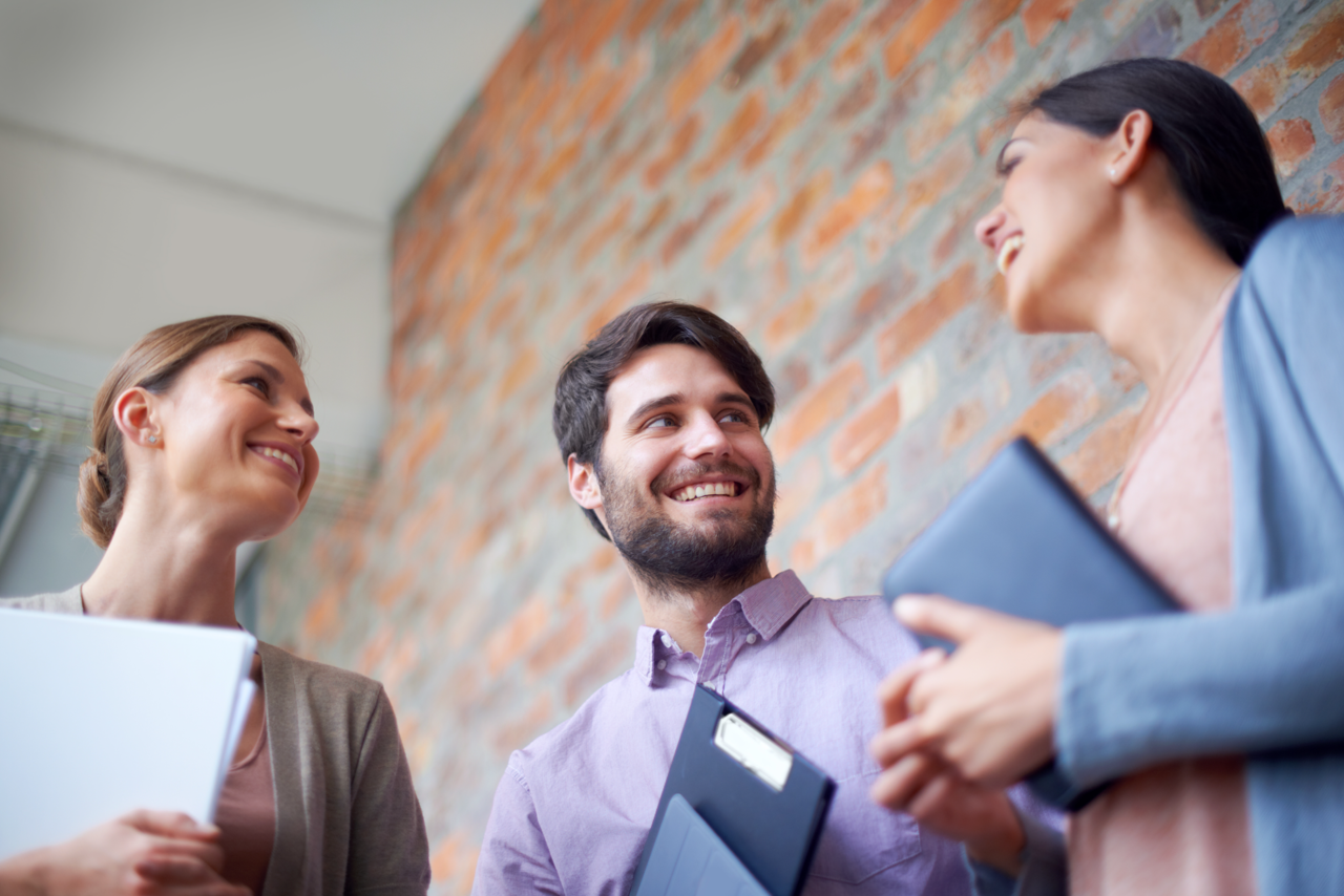 3 people talking outside a building