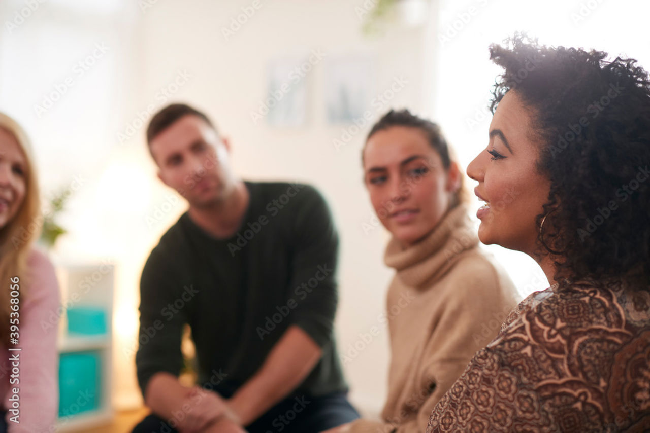 3 people speaking outside in a green area