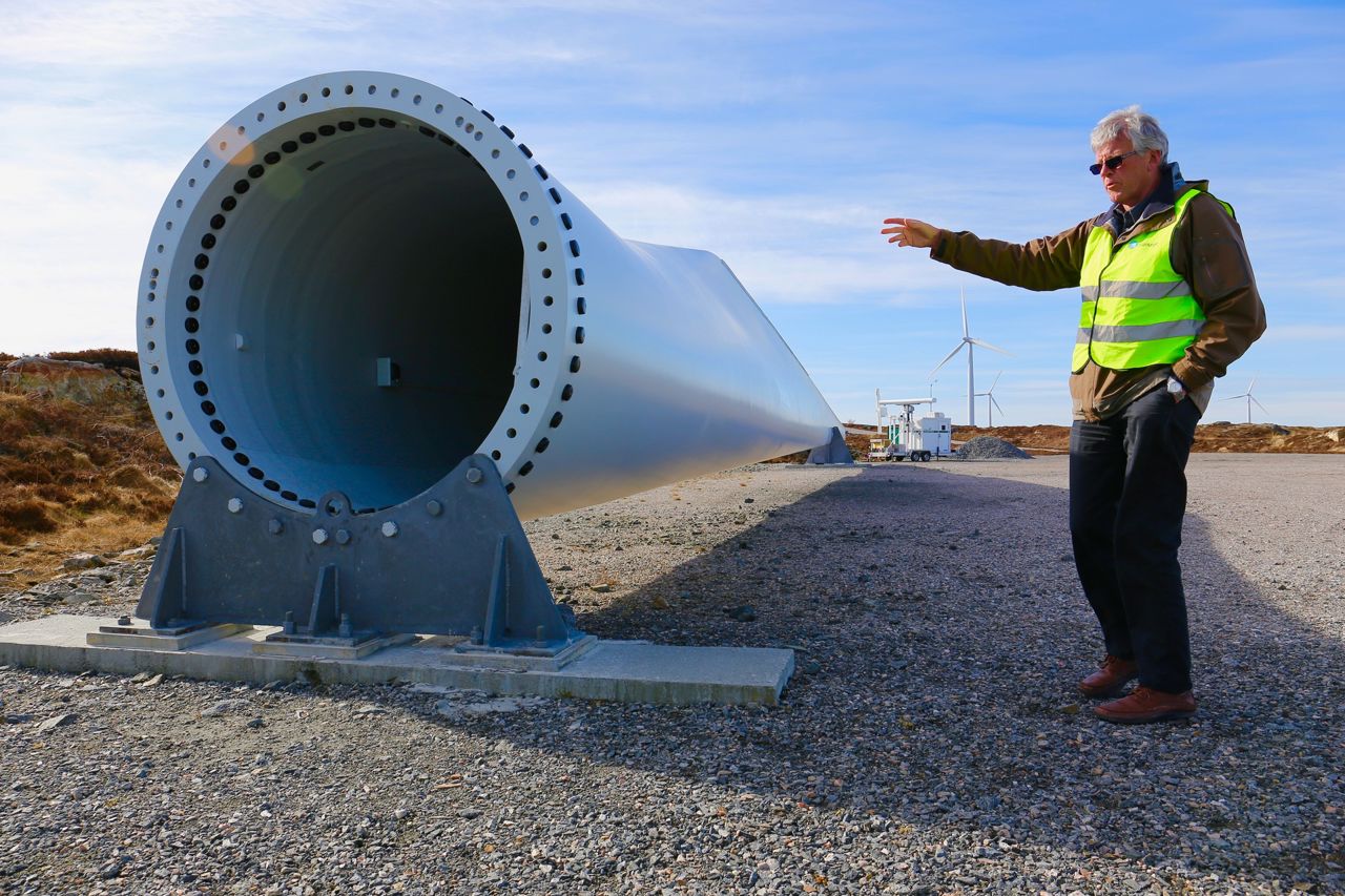 Engineer standing in front of a wind turbine