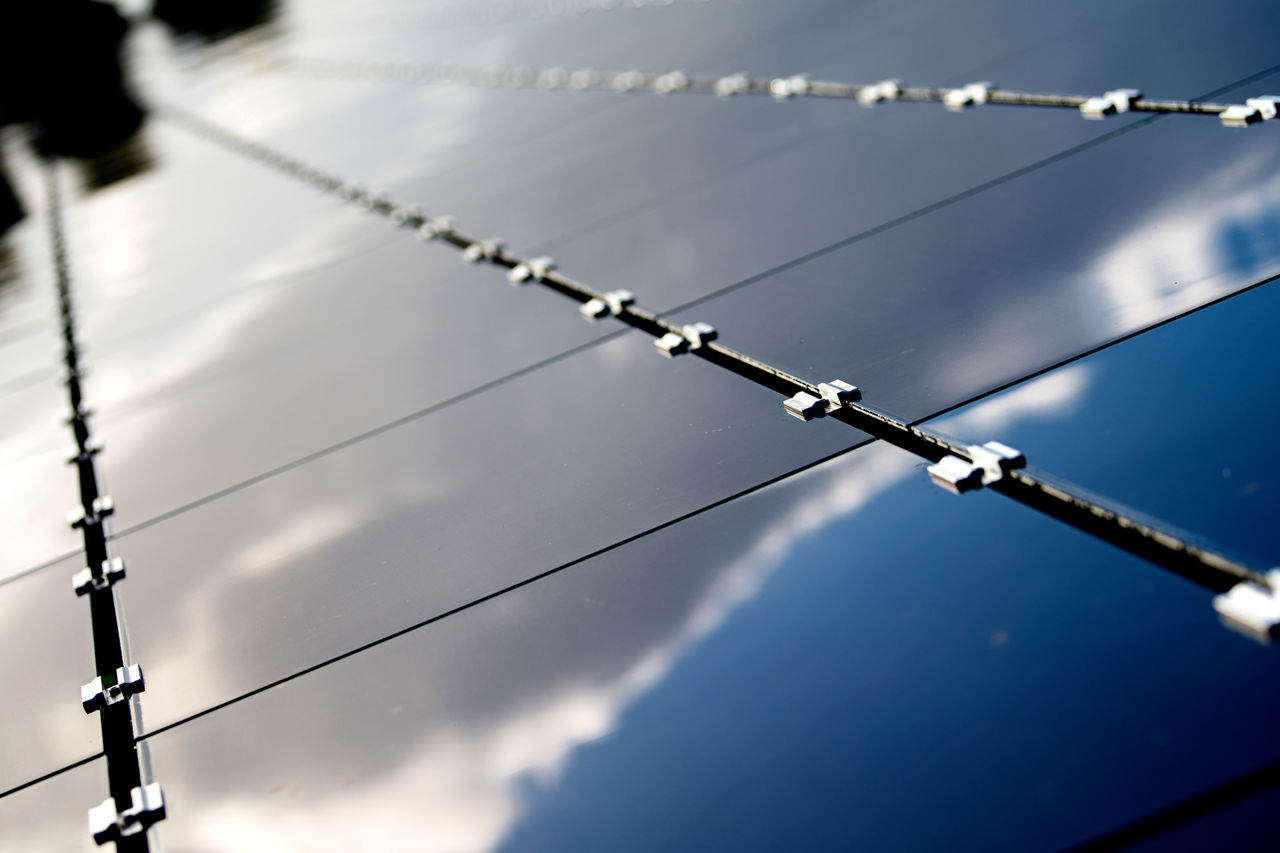 Solar panels with sky reflection 