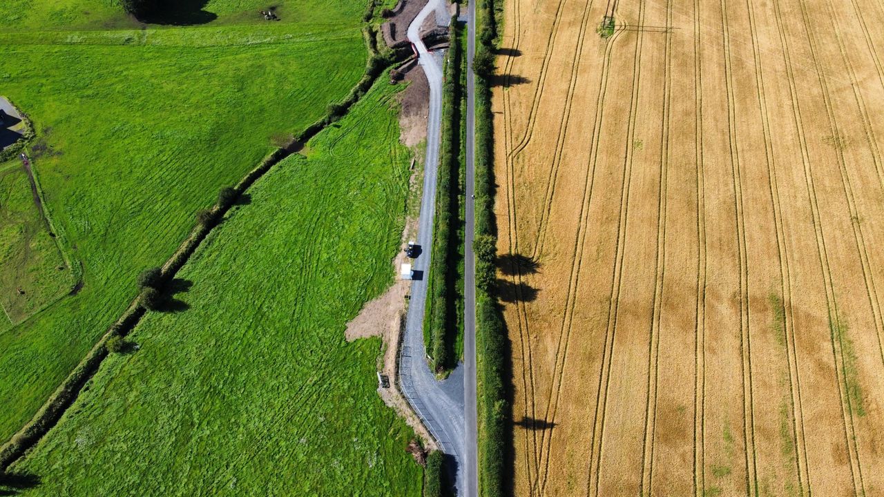 Aeriel view of farm with access road in the middle